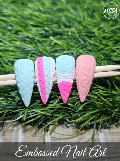 A collection of various nail art samples, from celestial and gold-leaf designs to embossed sweater patterns and fruit art, all showcasing the diverse skills our students learn at the academy.