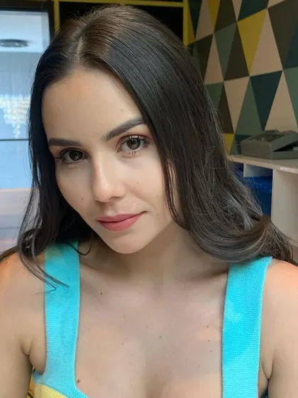 A soft glam look for an e-commerce shoot. The makeup is clean and minimal, designed to enhance the model's features without distracting from the product she is modeling.