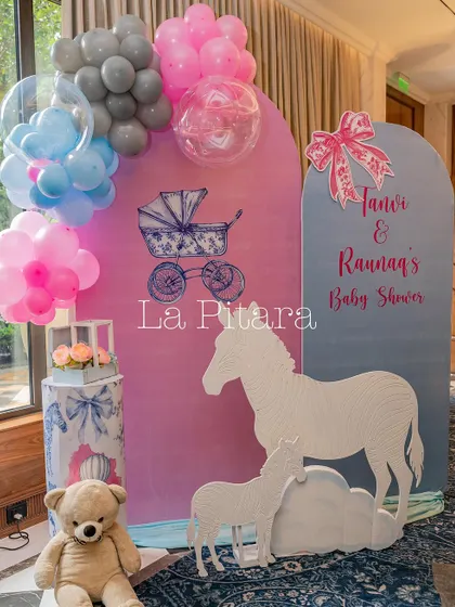 A photo corner with a teddy bear, themed props, and a balloon arrangement, perfect for capturing memories.