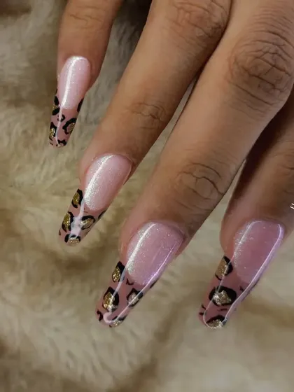 A close-up of the leopard print French tip nails, showing the clean lines and detailed pattern.