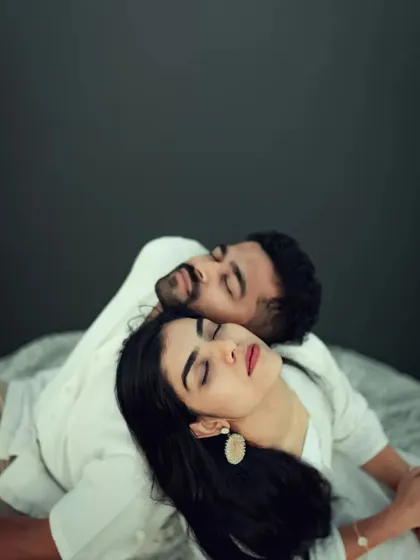 A creative and intimate pre-wedding portrait with the couple resting together, showcasing a peaceful and artistic side of their connection.