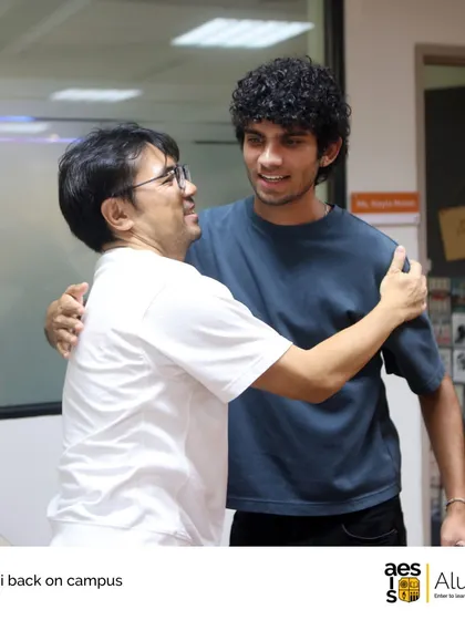 A teacher and a former student share a warm hug during an alumni reunion on campus. These moments capture the heart of our community.
