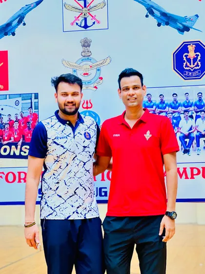Though we may play for different teams, we are united by our love for volleyball. Pictured here with a fellow player against a backdrop celebrating the armed forces teams.