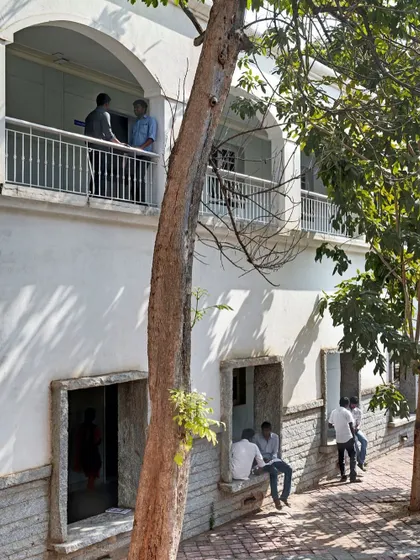 Informal seating nooks are carved into the building's facade at ground level, providing students with shaded spots to sit and talk. These small design interventions play a large role in fostering a sense of community and social energy on campus.