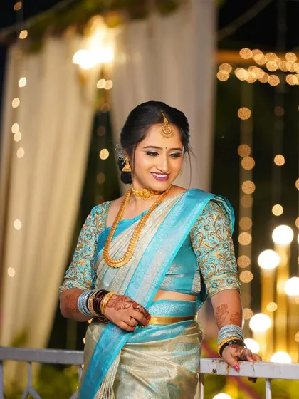 Aishwarya looking stunning against a backdrop of fairy lights. Her blue and silver saree is paired with a soft glam makeup look.