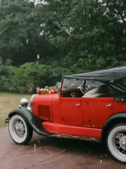 The baraat arrives in style, even in the rain. For Ayesha and Abhishek's wedding, the groom made his entrance in a vintage car, and the celebration continued with umbrellas and unstoppable dancing.