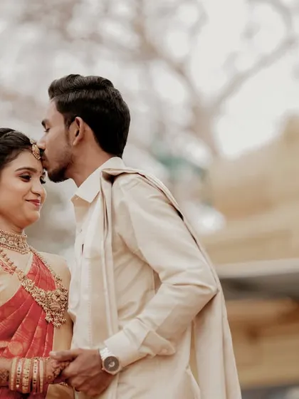 A tender forehead kiss, capturing the love and blessings of the wedding day in Tirupur.