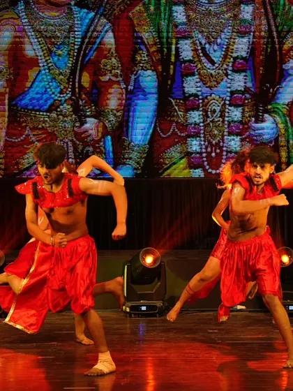 Dancers executing a powerful, athletic move in our contemporary piece inspired by the might of Bajrangbali.