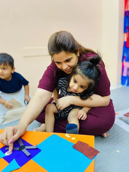 A mother and daughter are deeply engaged in their craft project, showing the focus and concentration these activities encourage.