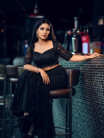 A classic fashion pose at the bar. This shot balances the model and the environment to tell a story of urban sophistication.