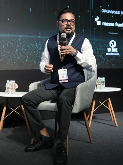 A panelist passionately makes a point during a discussion, showcasing the dynamic and engaging nature of our conference sessions.