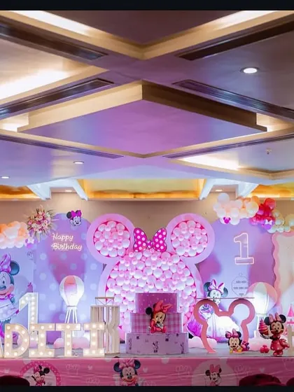 A wide shot of the Minnie Mouse birthday stage, showing the full scale of the decoration in a large banquet hall.