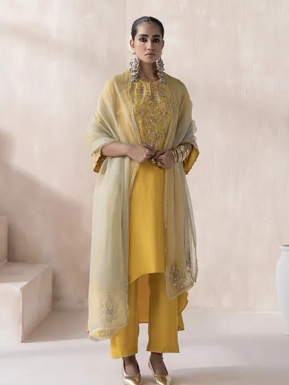 This full-length shot from the Saisha 'Firdaus' lookbook features a mustard yellow kurta set. I styled it with an embroidered organza dupatta and statement earrings to present a complete, ready-to-wear festive look.