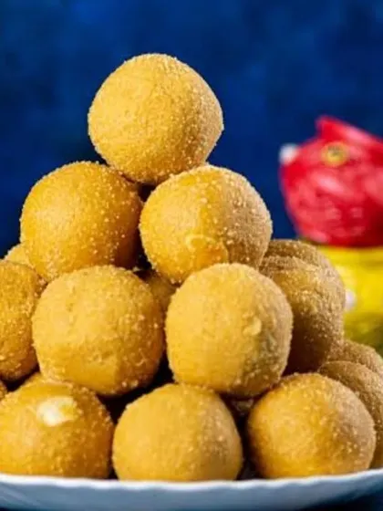 A stack of laddus appears in our Holi sweets promotion, where Besan Laddu is one of the named menu options.