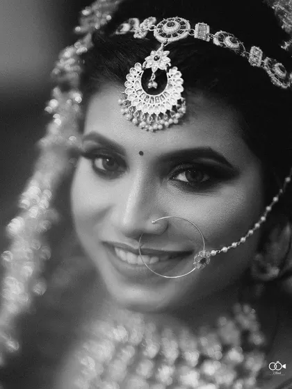 A stunning black and white close-up of the bride, her eyes and jewelry sparkling.