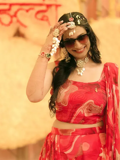 The bride looking cool and chic in sunglasses during her vibrant Haldi ceremony.