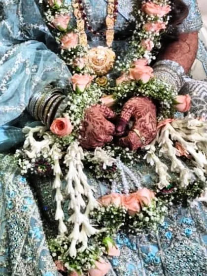 A bride's hands adorned with floral jewelry and my beautiful henna, which has developed into a stunning dark stain.