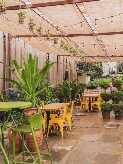 The main seating area, with string lights casting a warm glow over the space. It’s designed to be comfortable for both large groups and intimate dates.
