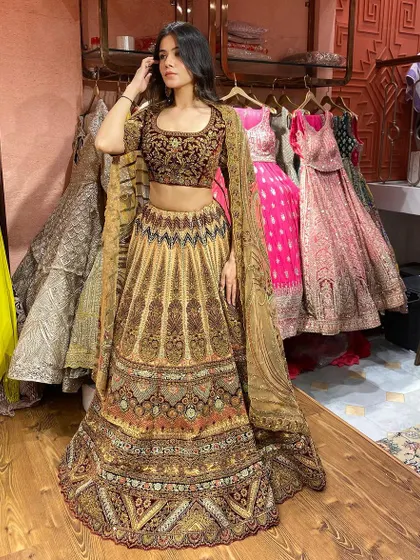 Make a grand entrance in this heavily embroidered masterpiece. The rich colors and traditional design make it a great choice for a close family member at a wedding.