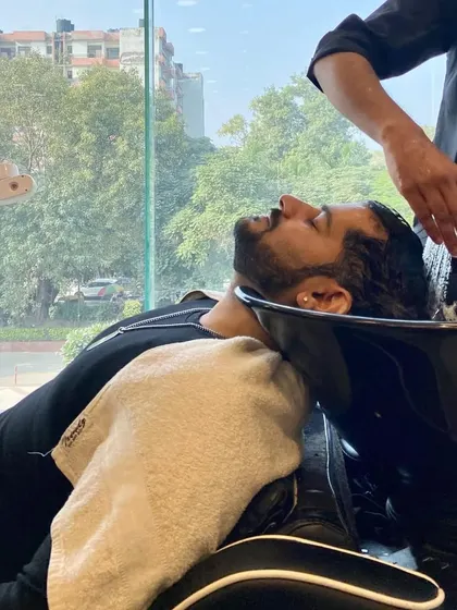 The grooming experience starts with a relaxing hair wash. We ensure every step of your visit is comfortable and professional.