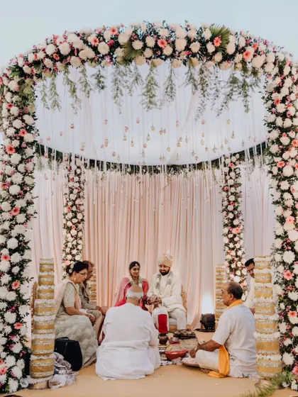 The serene setting of Mohit and Shikha's beachside wedding ceremony, under a beautiful floral arch.