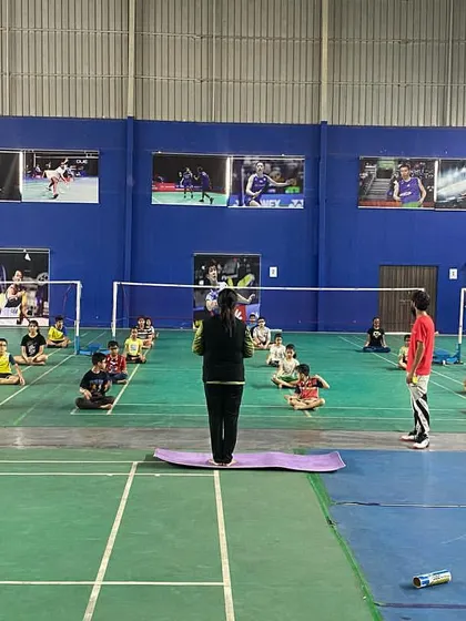 The entire group sits for a guided meditation. This practice helps them develop the discipline and focus needed to block out distractions and perform at their best.