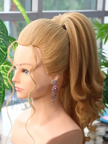 A side view of the pop-out unicorn ponytail, highlighting the height at the crown and the soft curls. This is a very flattering and stylish choice.