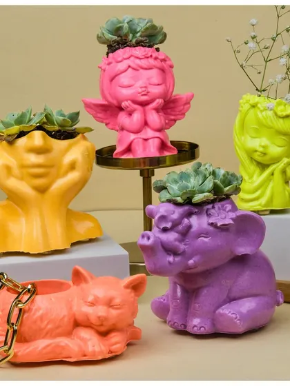 My collection of handcrafted Jesmonite planters is all about adding a pop of personality to your space. This image shows the variety of quirky, vibrant figurine shapes I offer, from playful cats to serene angels, each ready to hold a small plant or your favorite trinkets.