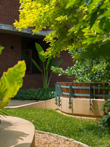 **Playfold, Ahmedabad:** The edge of the bench meets the lawn, creating a soft transition between different surfaces. The design carefully considers every detail to create a cohesive and harmonious landscape.