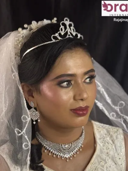 A beautiful Christian bride makeover with dewy makeup, a key trend you'll learn in our courses. The look is completed with a delicate tiara and veil.