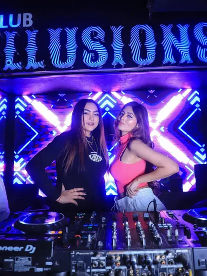 Posing for a photo in the DJ booth at Club Illusions, ready for a great night.