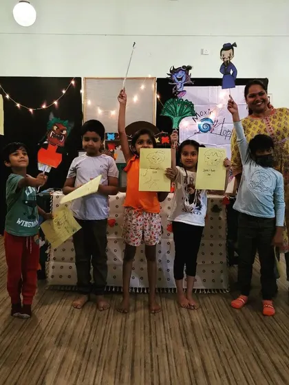We are the story! Kids holding up the puppets and artwork they created during one of our crazy, fun workshops. This hands-on activity helps them become characters in the adventure.