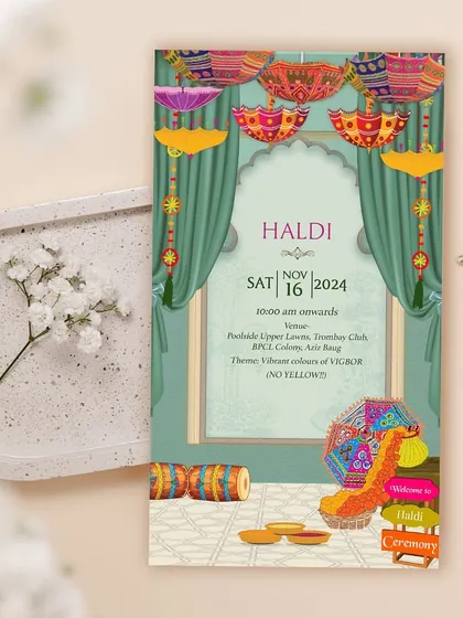 Who says Haldi has to be all yellow? This vibrant Haldi invitation plays with a spectrum of colors, featuring Rajasthani umbrellas and traditional decor to create a festive and unique look.