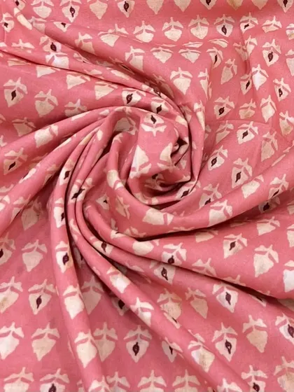 This printed mul mul cotton in a lovely pink shade is perfect for sunlit days. Its soft and breathable texture ensures comfort and style.
