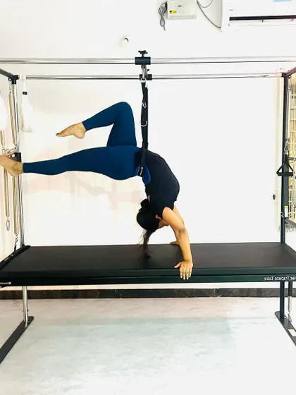 Using the push-through bar for a deep, controlled stretch, this pose improves flexibility while engaging the core for stability.