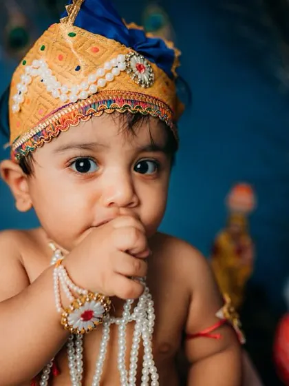 A classic baby moment, with his hand in his mouth. Even in full costume, I make sure to capture the simple, authentic actions that define this age.