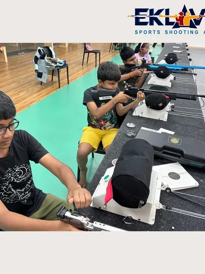 A young shooter carefully loads his air rifle, learning the process and safety protocols from the very beginning.
