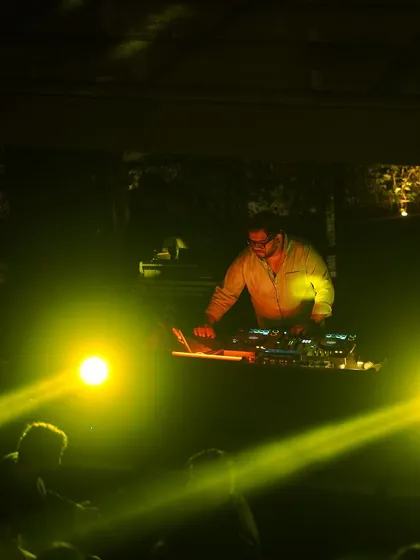 A focused shot of me at the console, with beams of light cutting through the darkness.