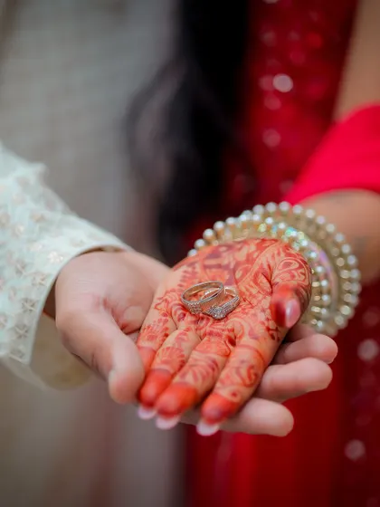 The wedding rings held in the bride's henna-adorned palm. I believe the small details tell a big story, so I always take time to photograph the rings, mehndi, and other elements that you've so carefully chosen for your day.