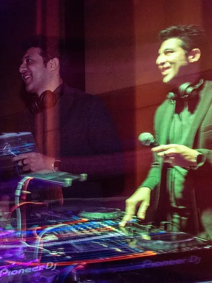 A creative long-exposure shot capturing the energy and movement behind the decks at the Prestige event.