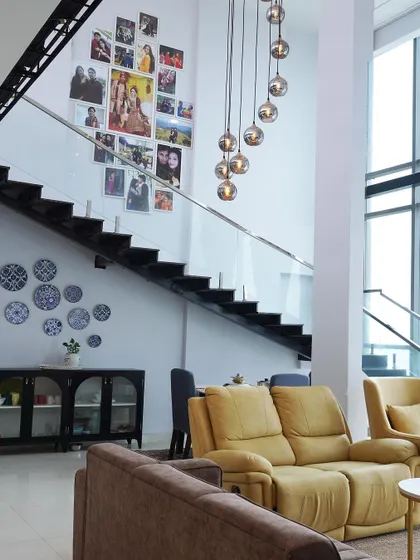 A personal touch makes a house a home. I created a beautiful photo gallery wall along the staircase, turning cherished memories into a stunning decorative feature in this double-height space.