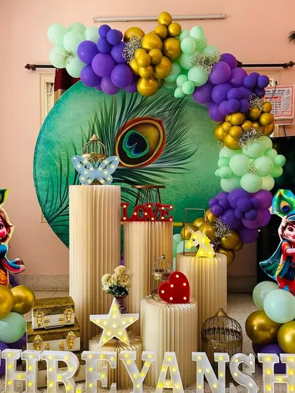 For a touch of tradition and fun, we offer a Little Krishna theme. This setup for Shreyansh includes a beautiful peacock feather backdrop, cutouts of baby Krishna, and a vibrant color scheme.