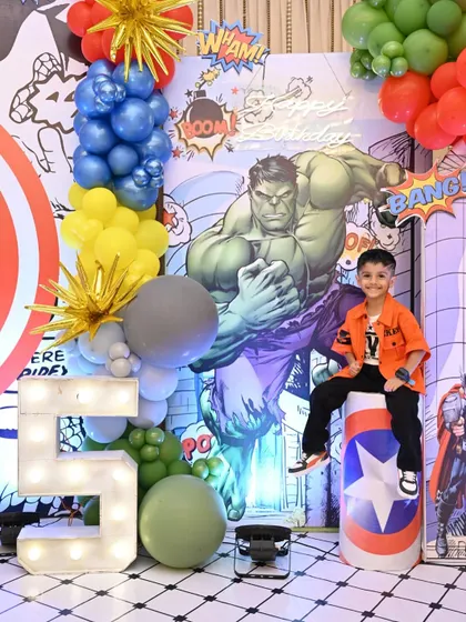 The birthday boy striking a pose in front of his epic Hulk-themed decor. Seeing this smile is my greatest reward.