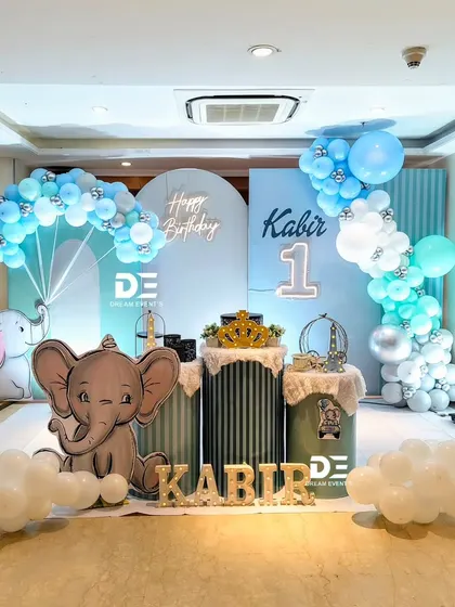A modern and stylish baby elephant theme for Kabir's first birthday. I used clean lines, arched backdrops, and a cool blue and white color scheme with cloud props on the floor.