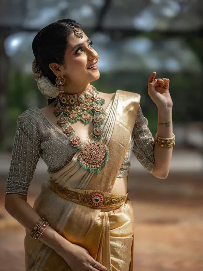 A joyful and radiant portrait of the bride, looking up towards the light. Her expression is one of pure happiness and anticipation.