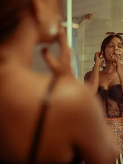 The smoke and the reflection create a layered, complex image with a very specific, cinematic mood.
