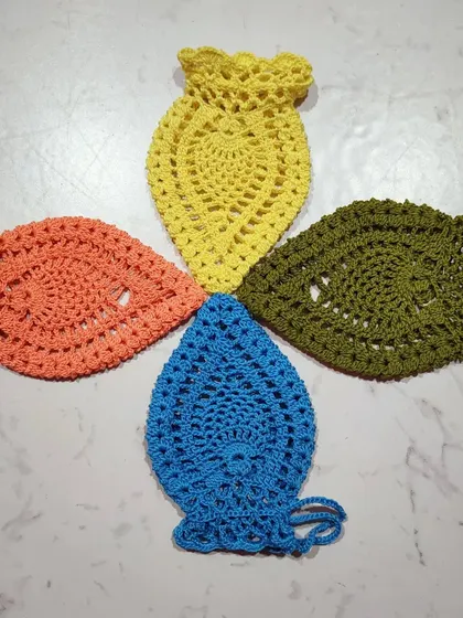 Four pineapple pouches arranged in a pinwheel. I love making these in various colors like orange, yellow, blue, and olive green.