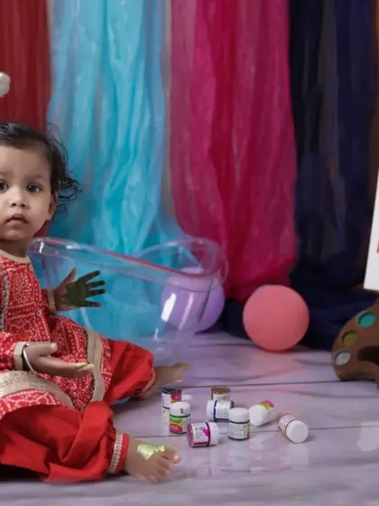 Getting creative for Holi! This little artist is ready to paint, surrounded by colors in our vibrant and playful festival setup.