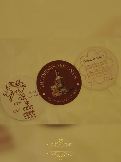 We love adding fun, personal touches. These custom coasters with witty phrases like "The drinks are on us, the hangover is on you" are always a hit with guests.