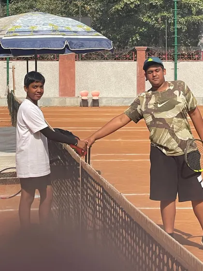 A friendly handshake at the net. The competitive spirit is always balanced with respect among our players.